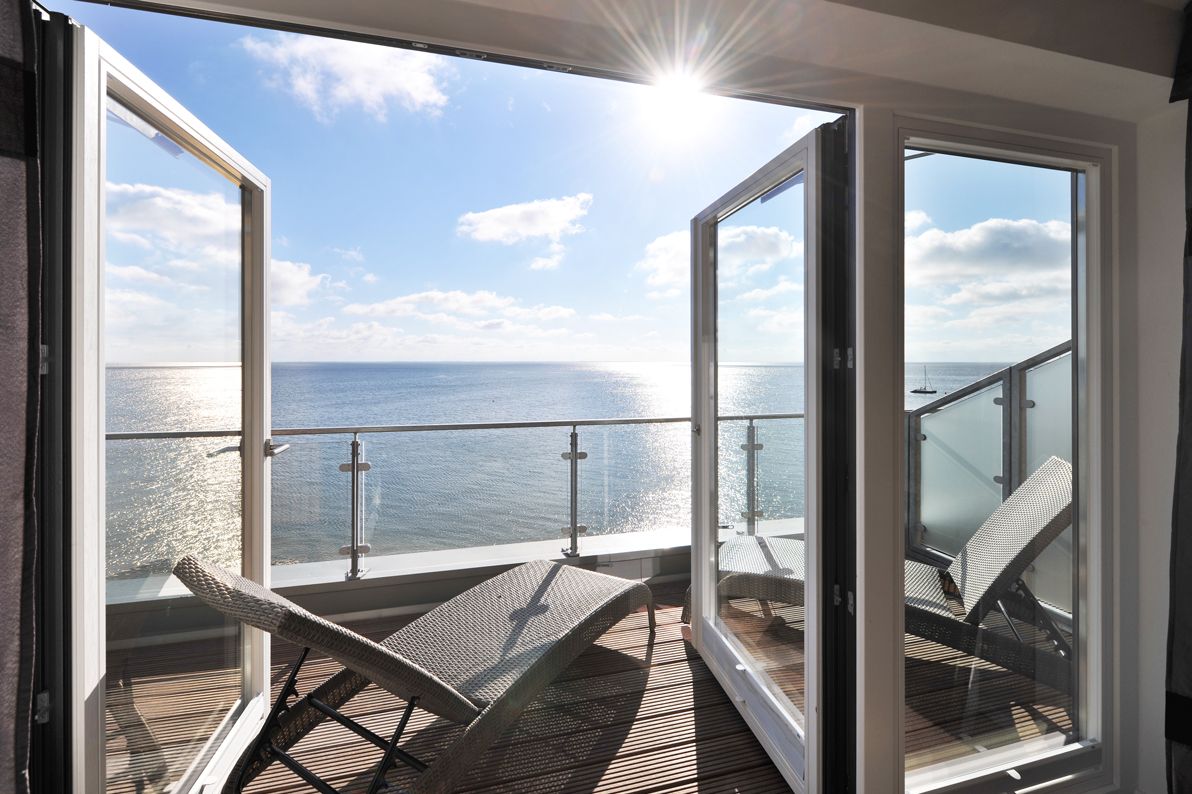 Terasse einer Mastersuite mit Liegen und einem traumhaftem Blick über das Wattenmeer